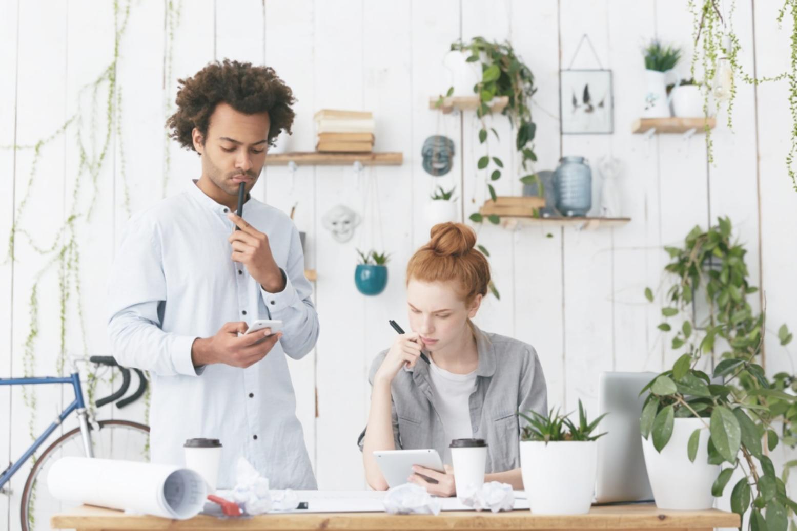 Small business owner reviewing financial reports on tablet in modern office setting