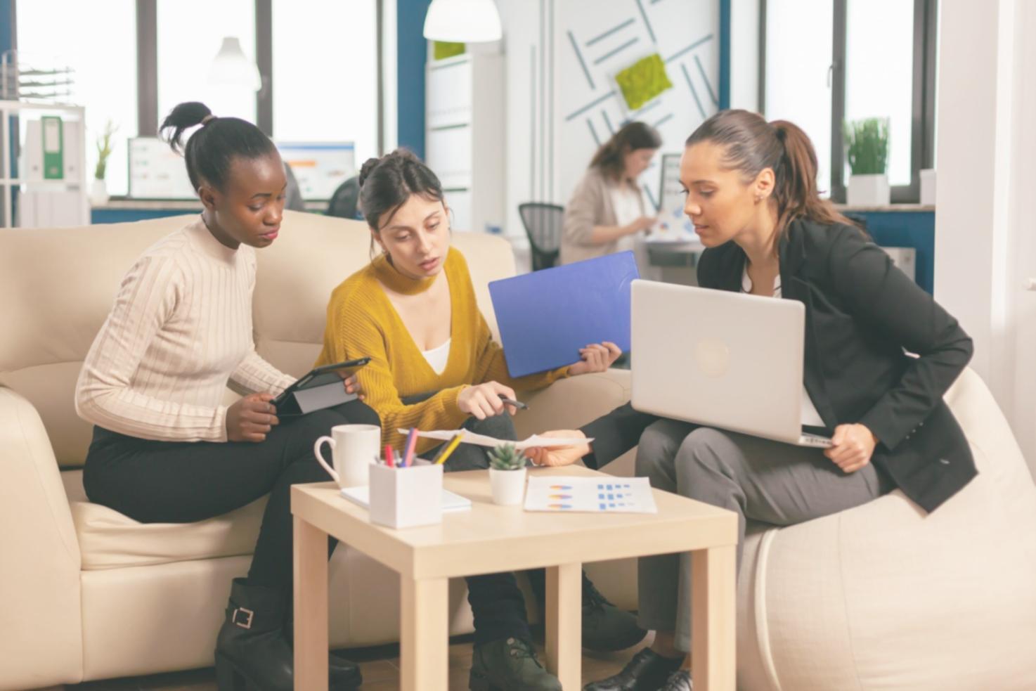 Clean modern office workspace showing financial planning documents and laptop computer