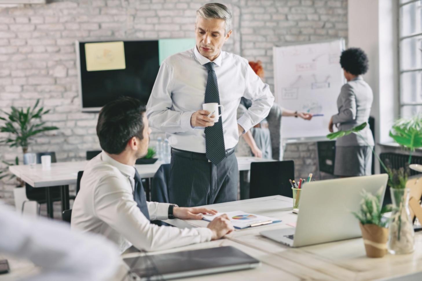 One-on-one mentoring session between instructor and student reviewing financial automation setup